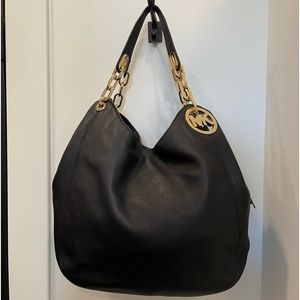 MK black purse with gold accents in excellent condition
